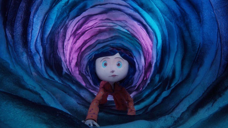 Coraline (fromt the animated film “Coraline”) crawls through a narrow tunnel, appearing nervous.